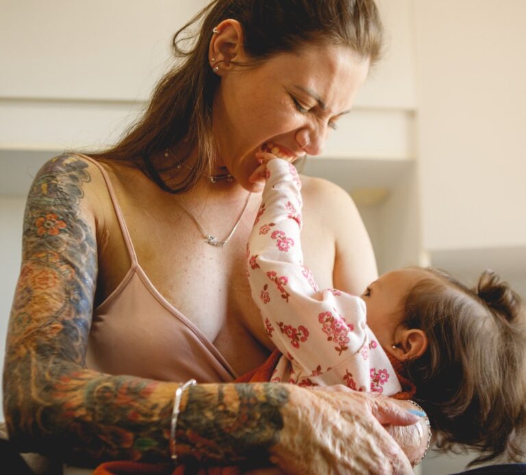 אשה מקועקעת מניקה